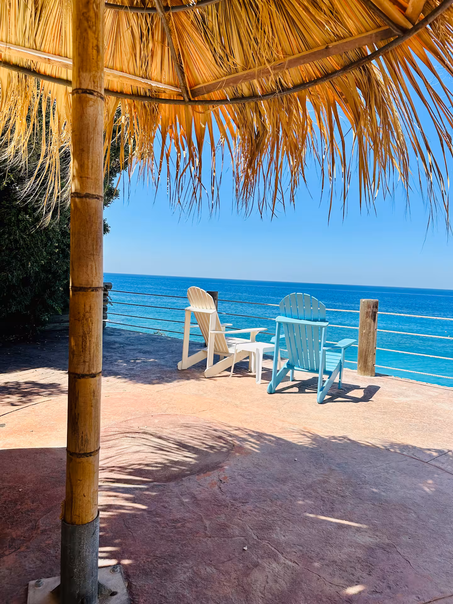 Chalet terrace with loungers and the sea beyond