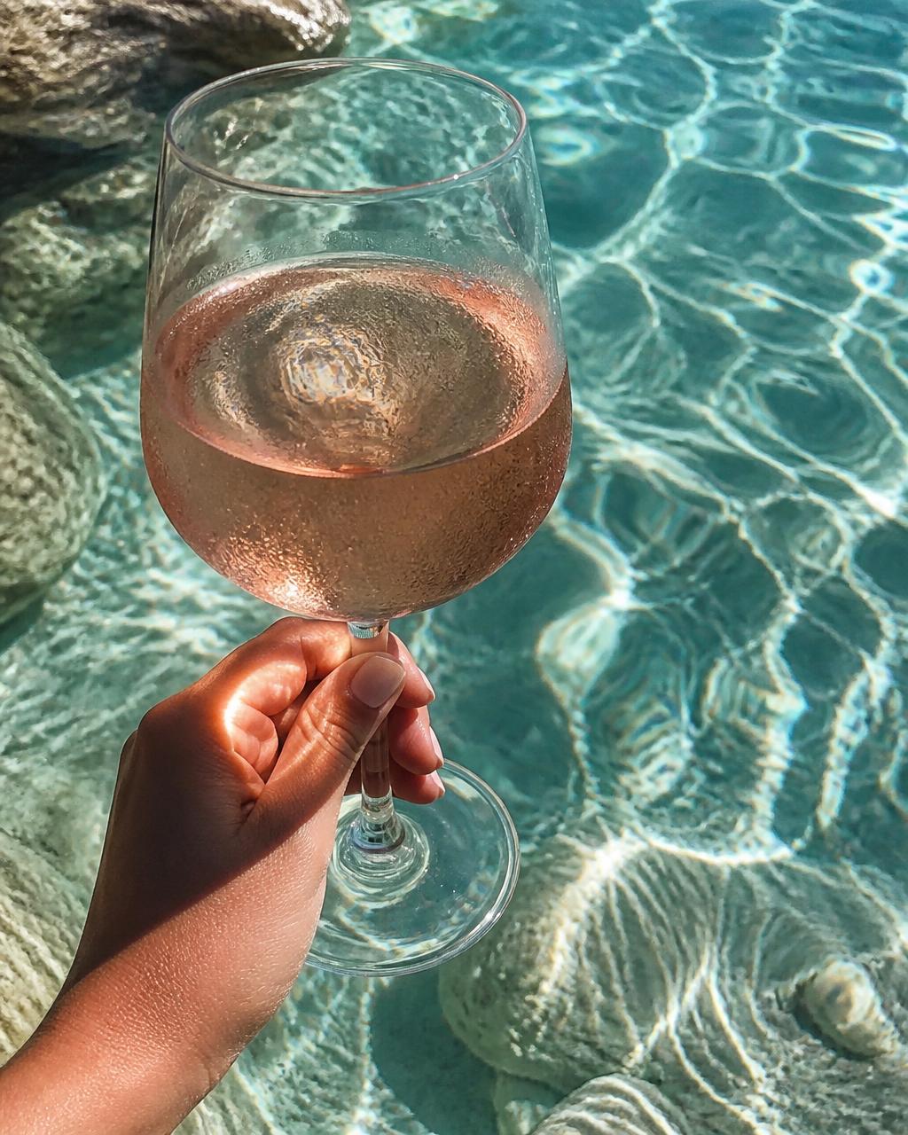 Chilled rosé poured at the pool edge